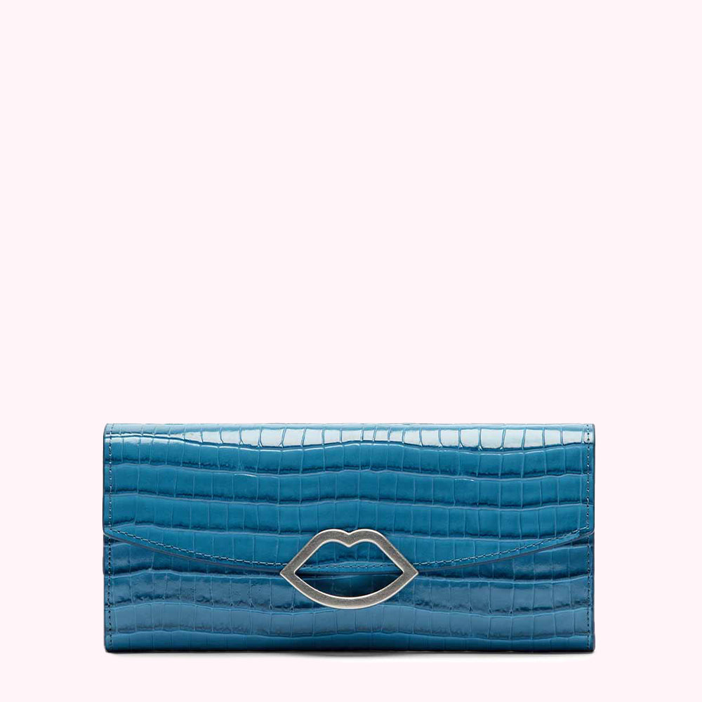 Teal crocodile-embossed leather wallet with silver lip-shaped clasp against a white background.
