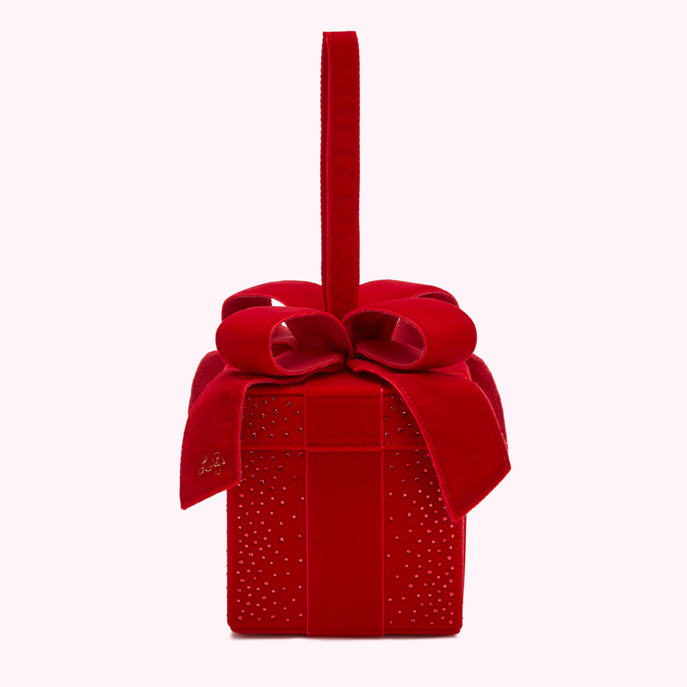 Red velvet gift box-shaped handbag with a large red velvet bow and a top handle. The box is embellished with small red crystals.
