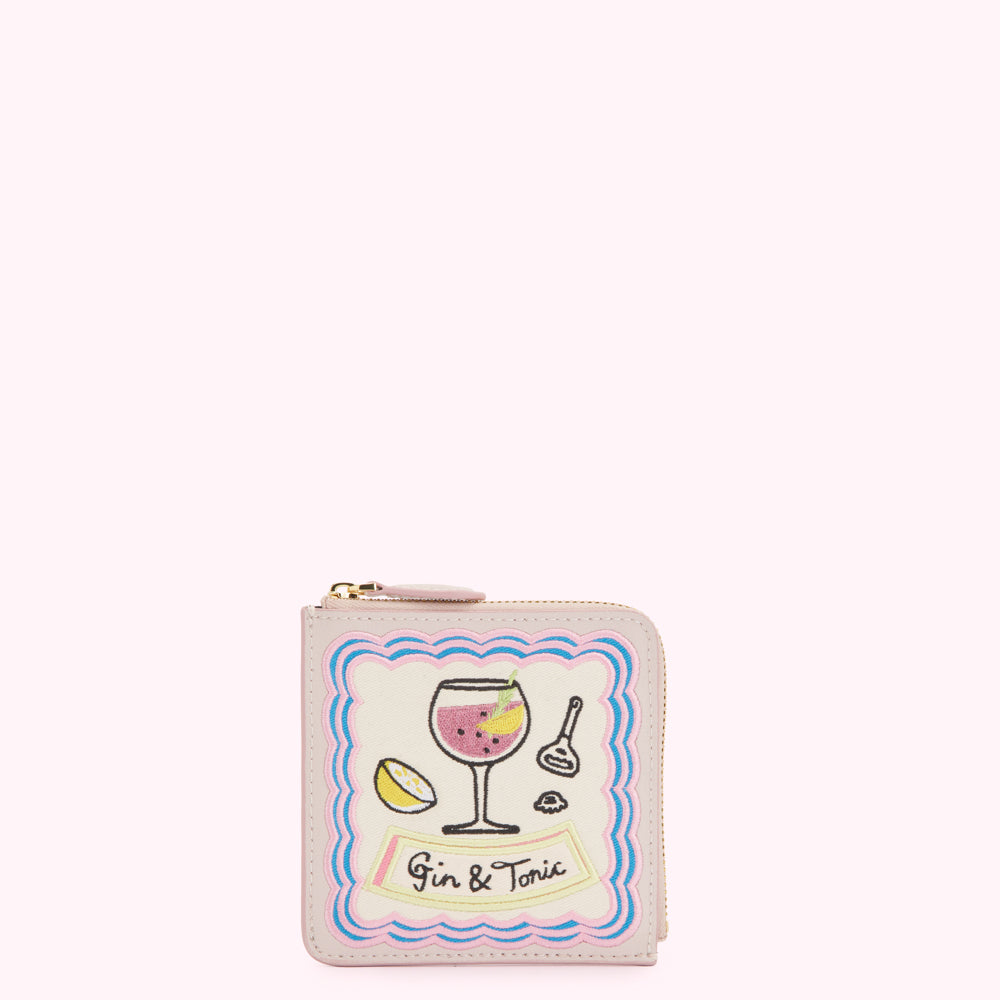 Pale pink leather zip-around wallet with embroidered gin and tonic design.
