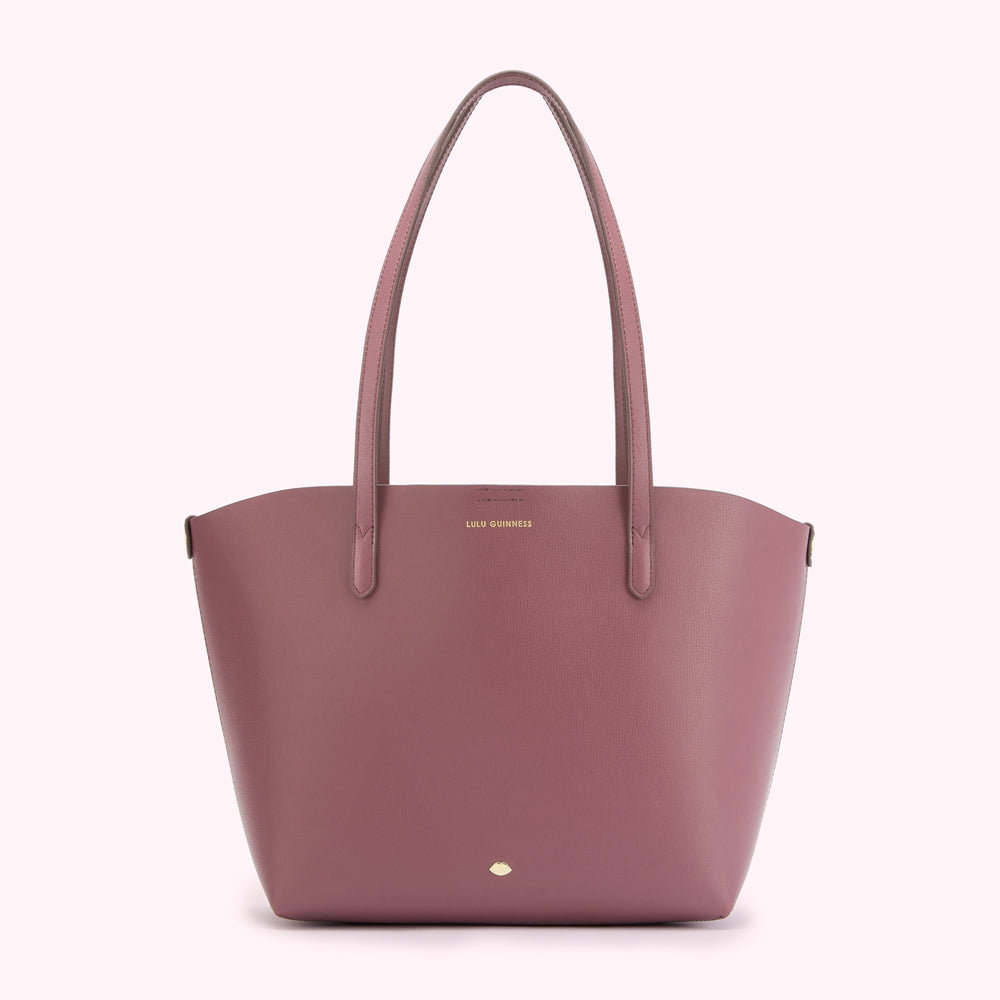 Dusty rose Lulu Guinness tote bag with gold logo.
