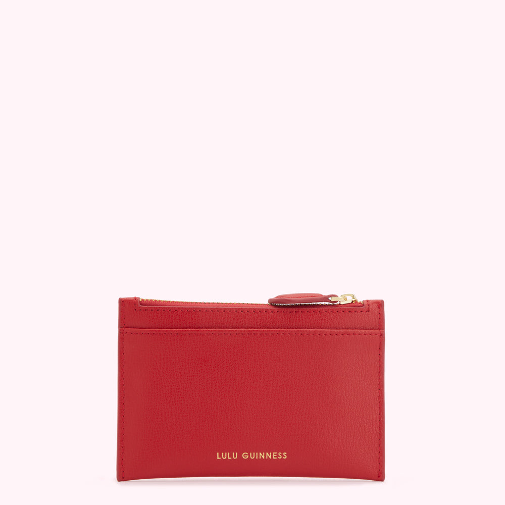 Red leather Lulu Guinness zip-around cardholder against a white background.
