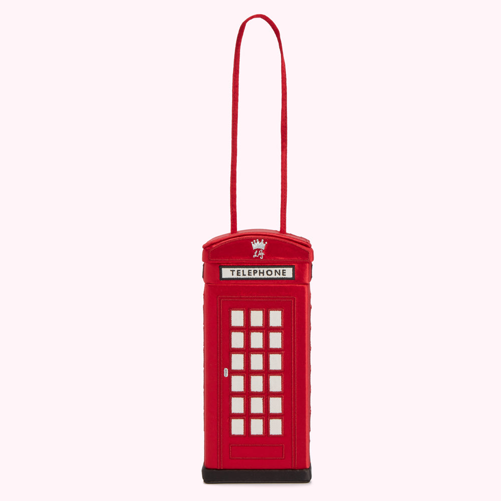 Red telephone booth-shaped handbag with a black base and a long red string for holding.