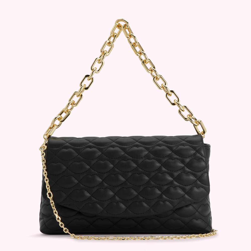 Black quilted crossbody bag with gold chain strap. The quilting is in the shape of lips.