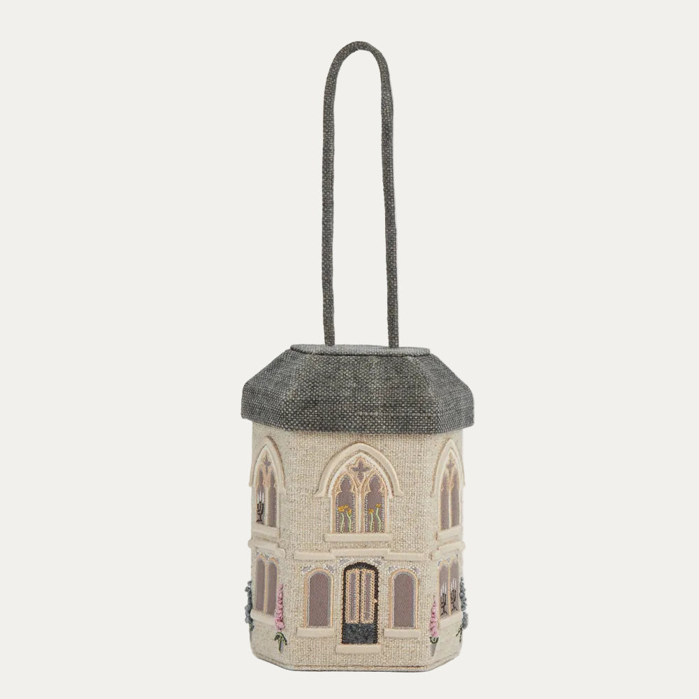 A beige house-shaped handbag with a grey roof and handle, embroidered with floral details.