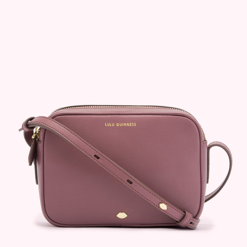 Dusty rose Lulu Guinness crossbody bag with gold zipper and hardware.