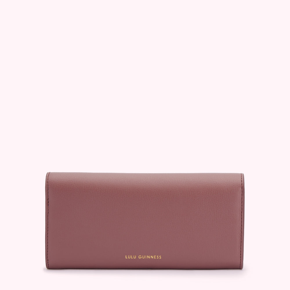A mauve Lulu Guinness wallet against a white background.

