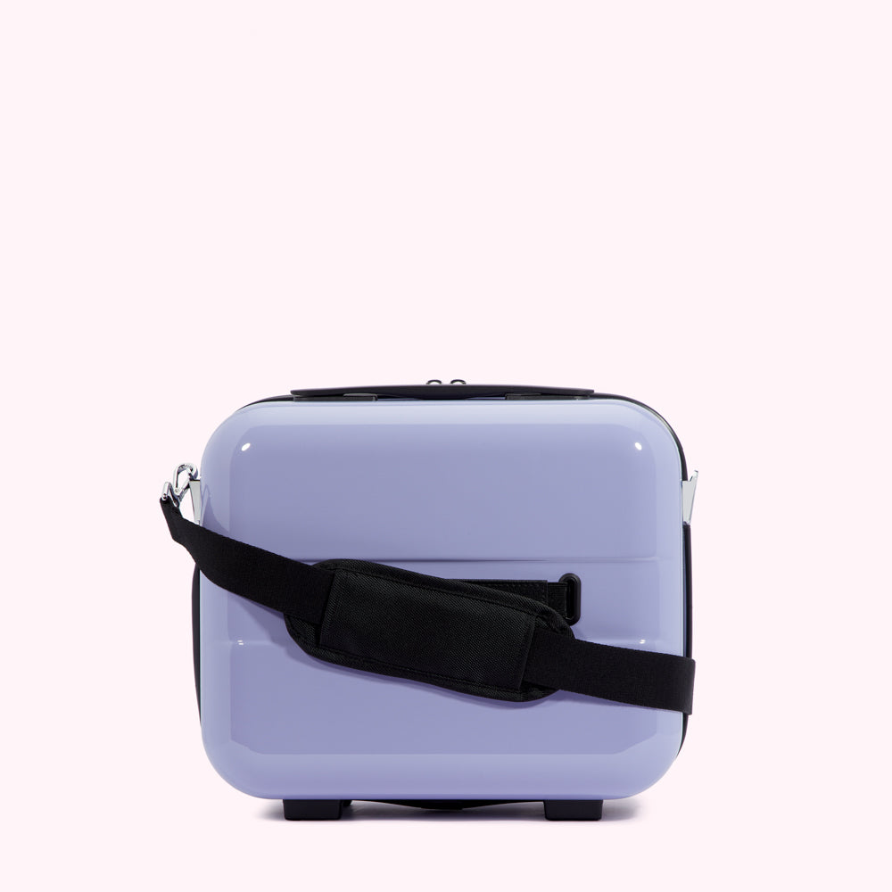 Lavender-coloured carry-on suitcase with a black shoulder strap.
