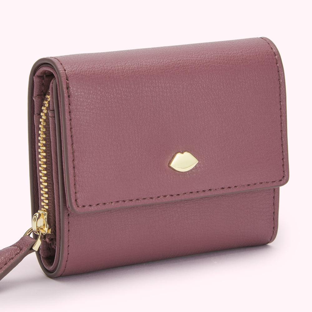 A purple leather wallet with a gold zipper and a gold lip-shaped logo. The background is white.