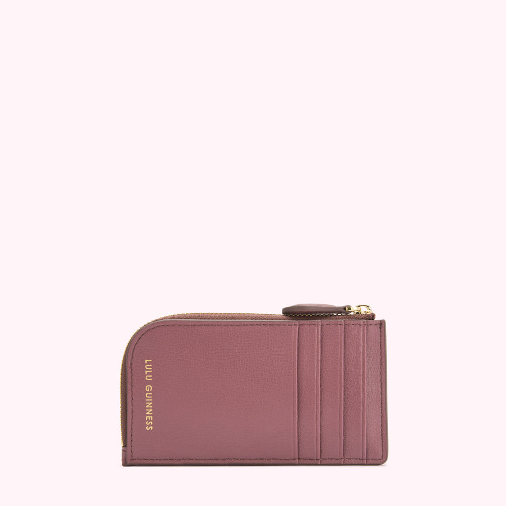 A dusty rose Lulu Guinness zip-around cardholder against a white background.