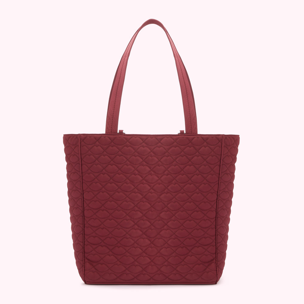 Burgundy quilted tote bag with lip-shaped pattern.