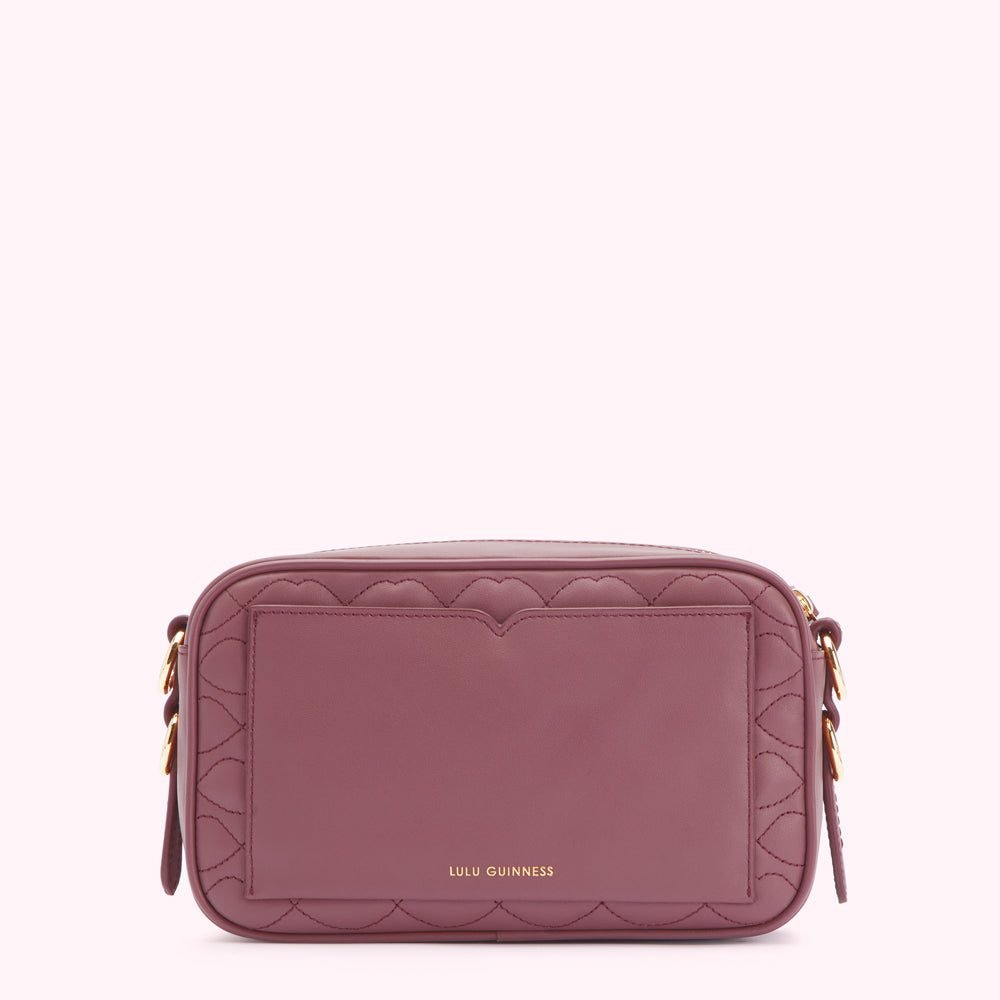 A quilted burgundy crossbody bag by Lulu Guinness.
