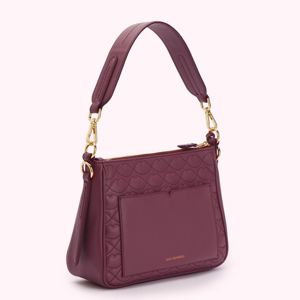 Burgundy quilted Lulu Guinness shoulder bag with gold hardware.