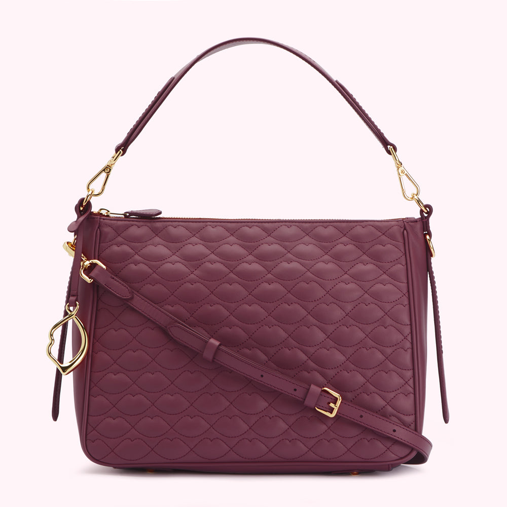 Burgundy quilted leather handbag with a gold-toned chain strap and lip-shaped pattern.