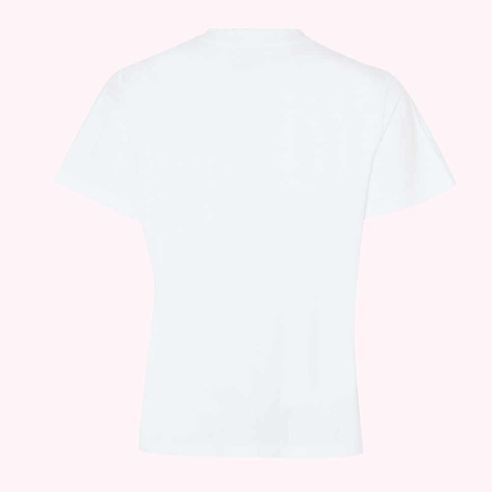 Back view of a plain white short-sleeved t-shirt on a pink background.

