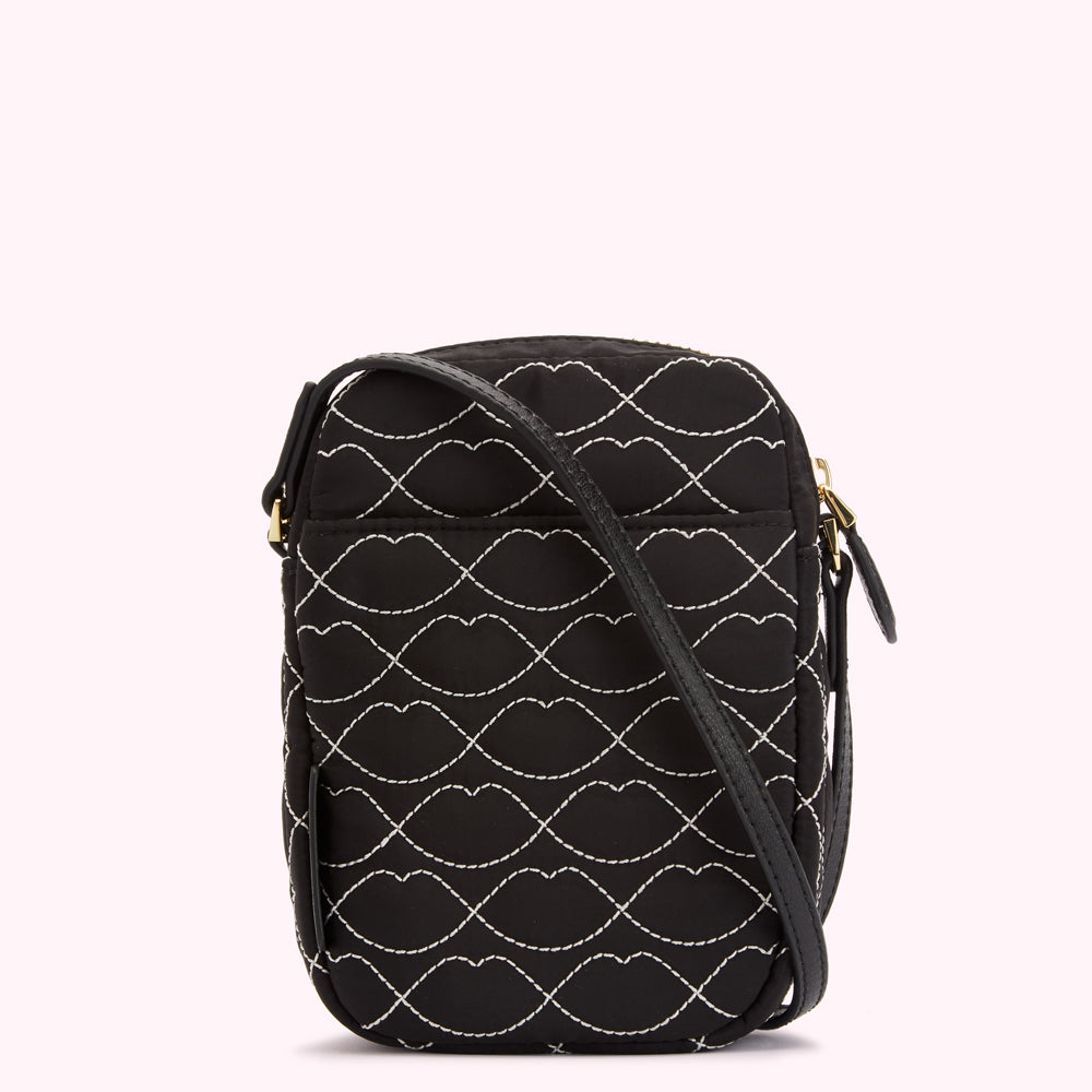 Black quilted crossbody bag with a lip print pattern.
