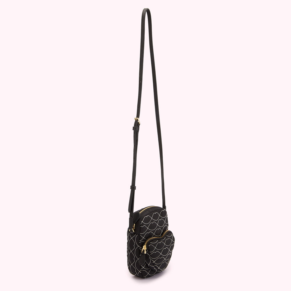 Black quilted crossbody bag with white stitching in a lip design.
