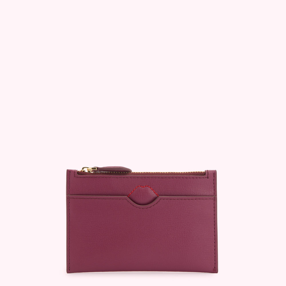 Purple leather card holder with gold zipper.
