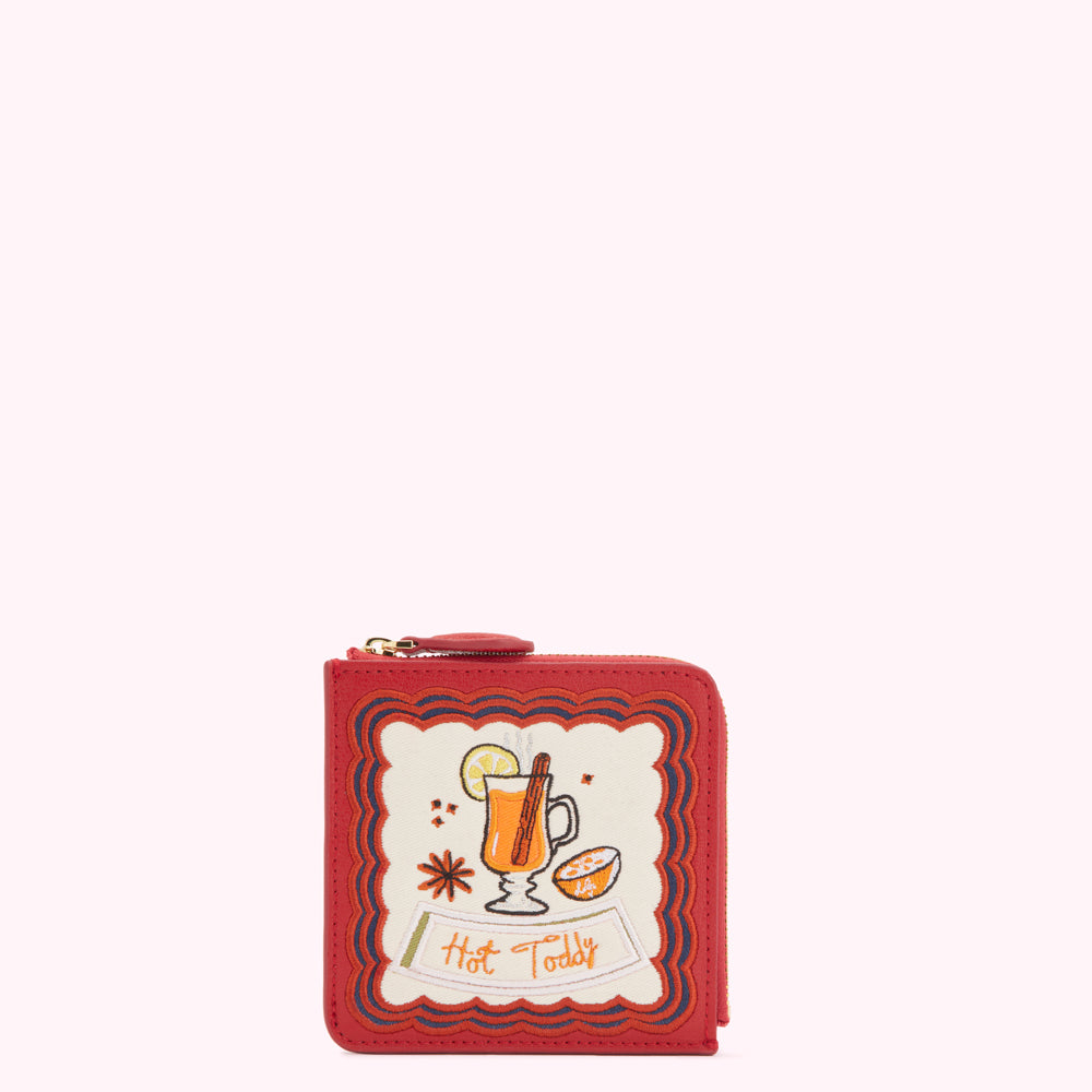 Red leather zip-around wallet with embroidered illustration of a hot toddy.
