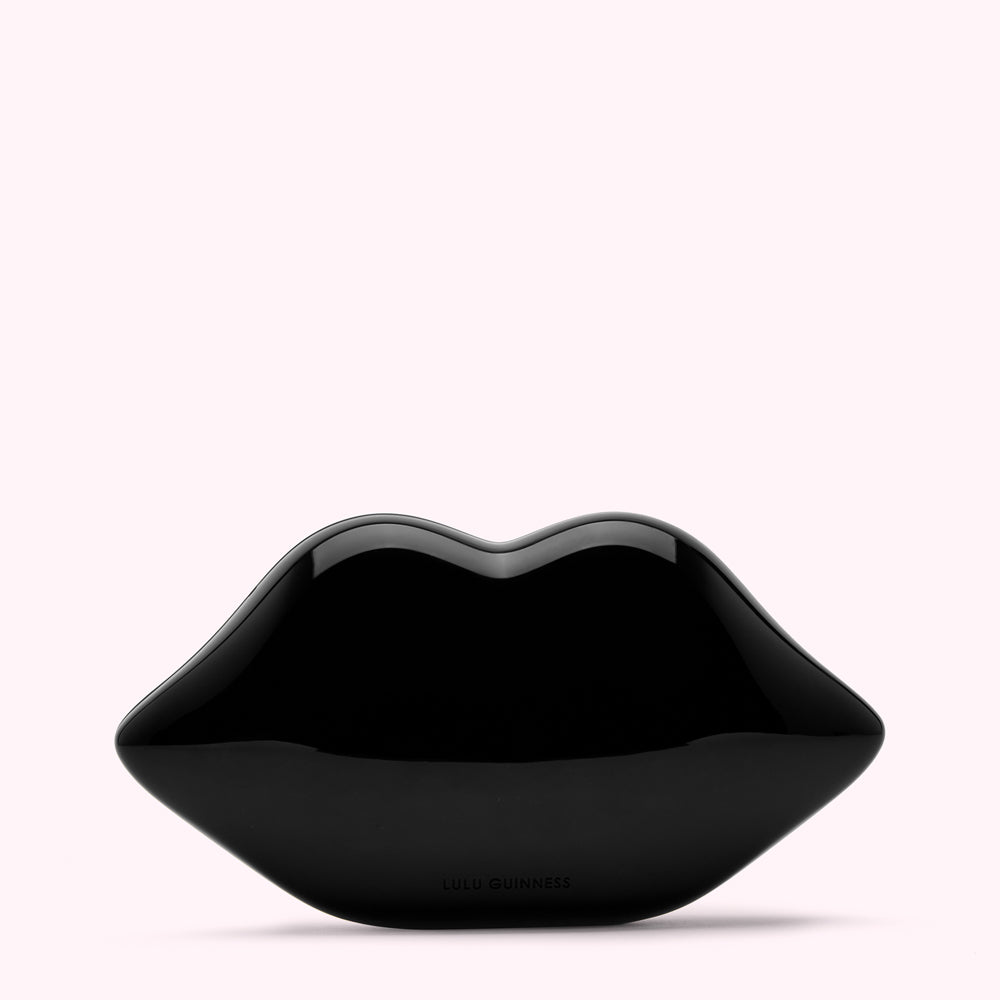 Black Lulu Guinness lip-shaped clutch on a white background.