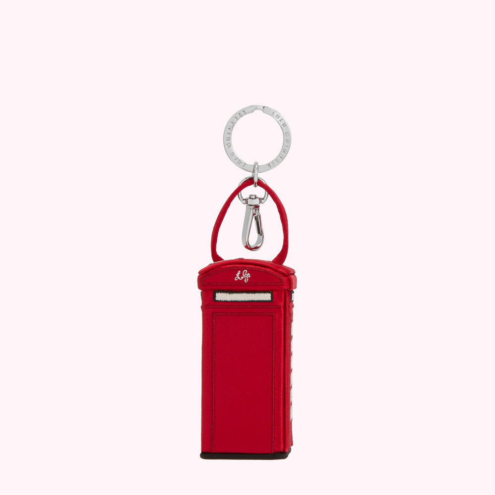 Red telephone booth-shaped keychain with silver ring and clasp.
