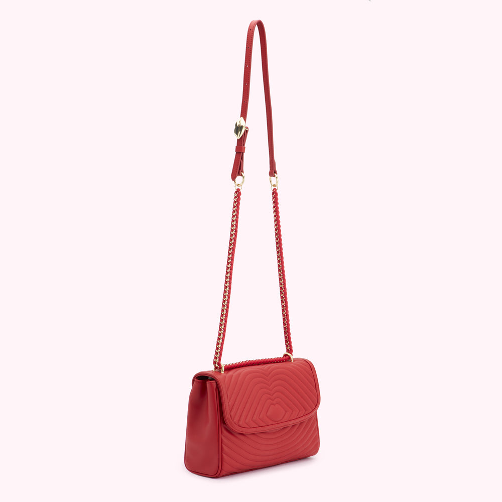 Red quilted crossbody bag with gold chain strap.
