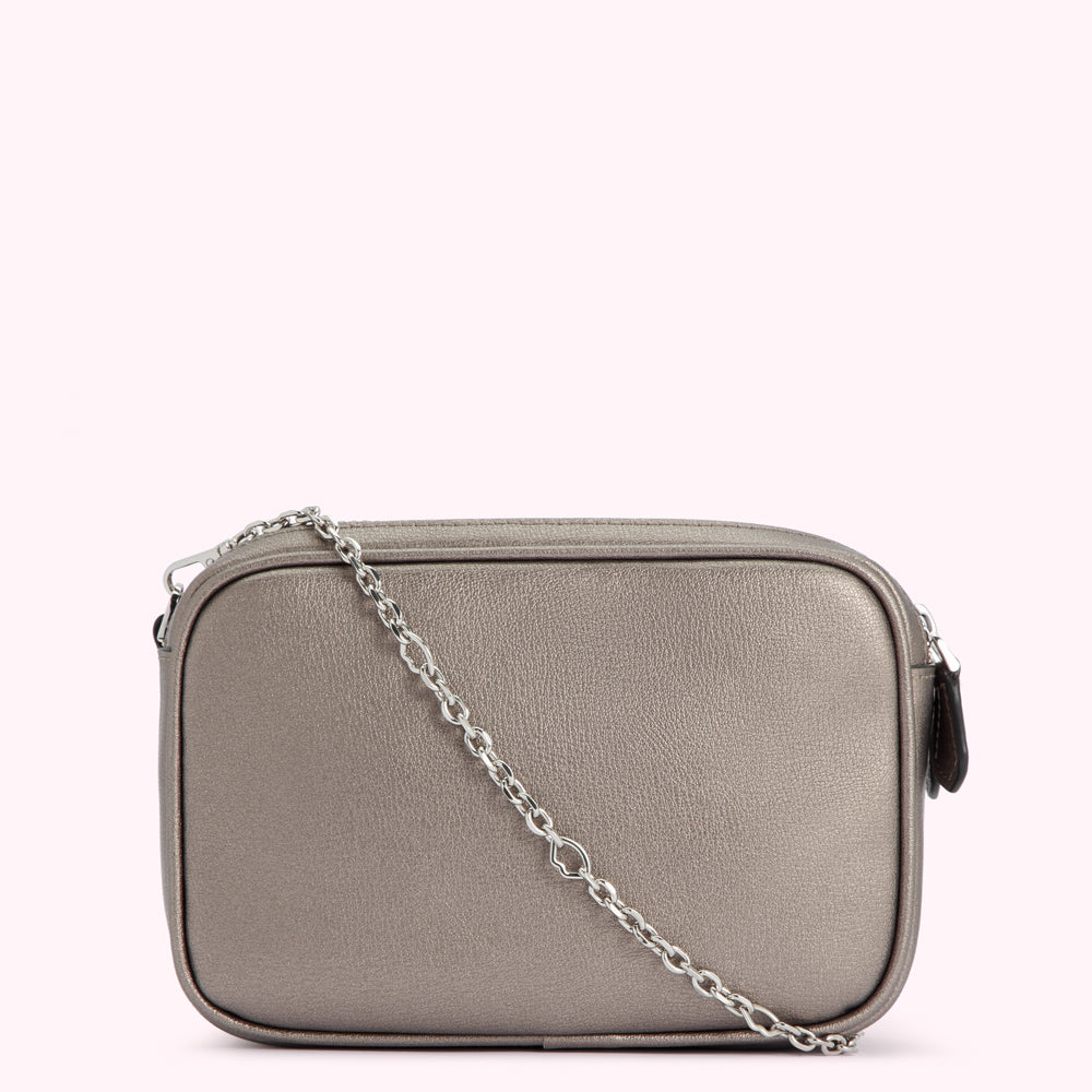 A silver rectangular crossbody bag with a silver chain strap against a white background.
