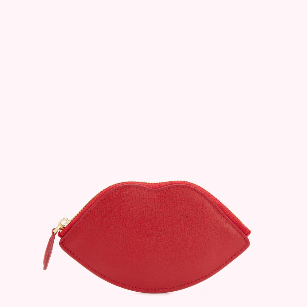 Red leather lip-shaped zipper pouch on white background.
