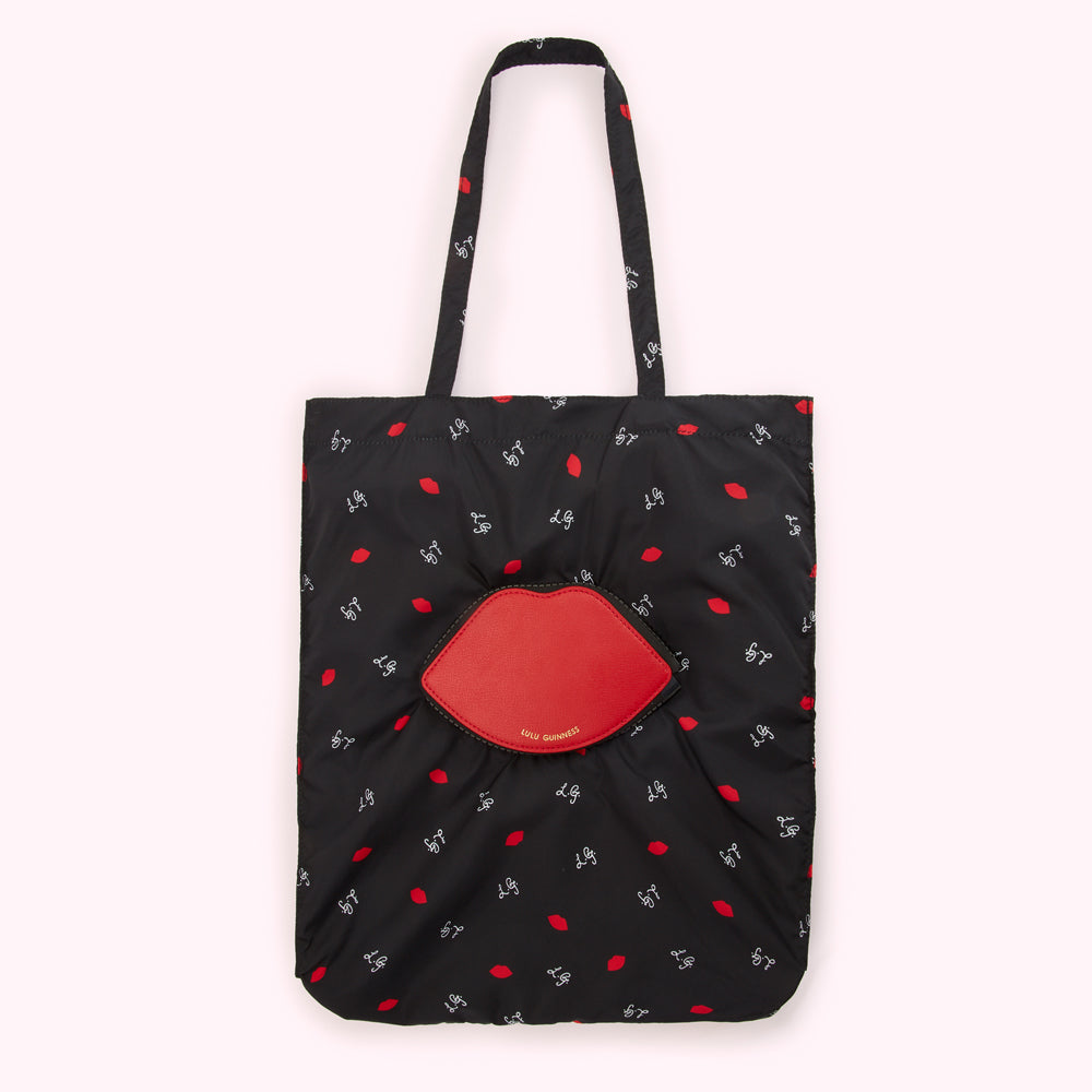Black tote bag with red lips print and a large red lip-shaped detail.