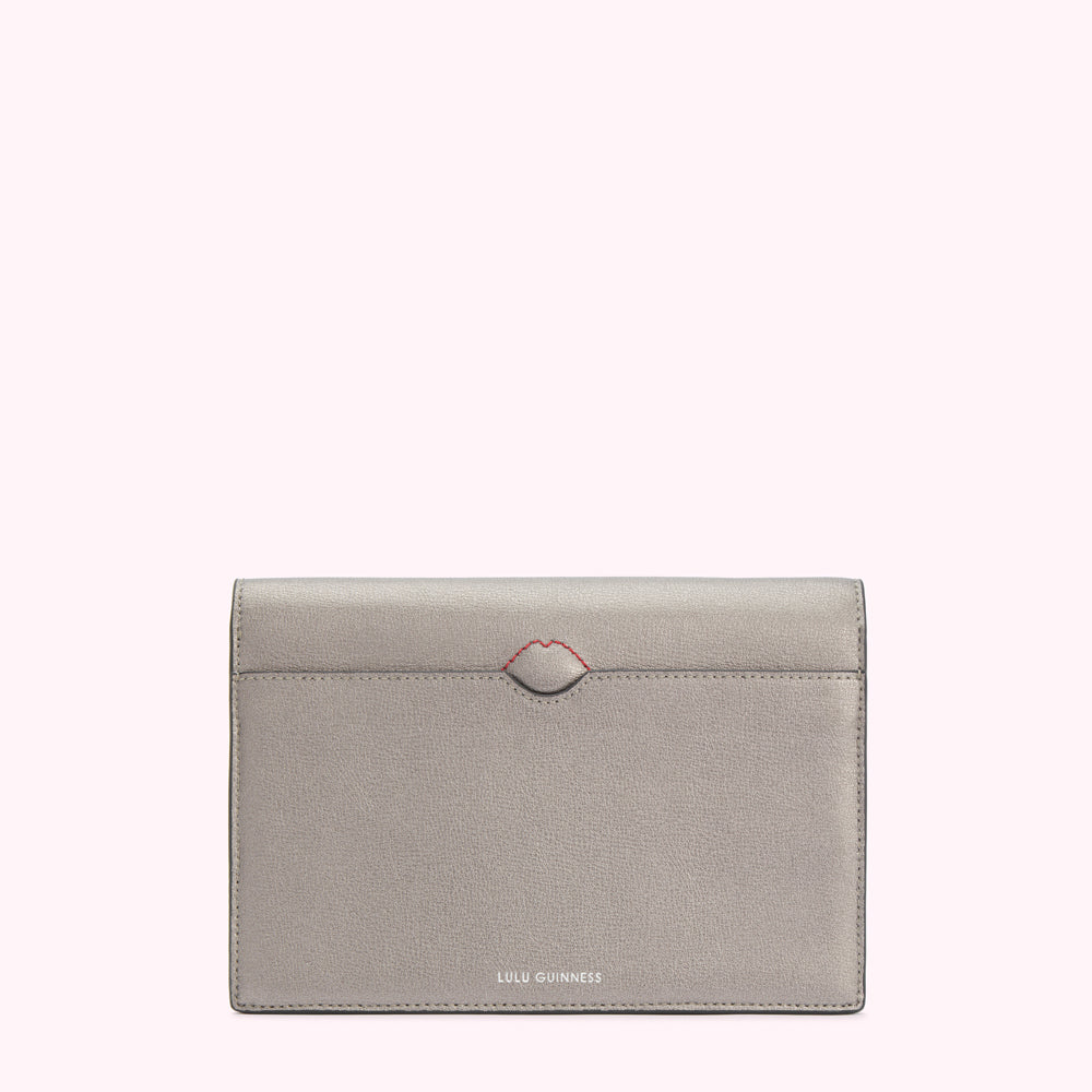 Silver Lulu Guinness wallet with a red lip detail.
