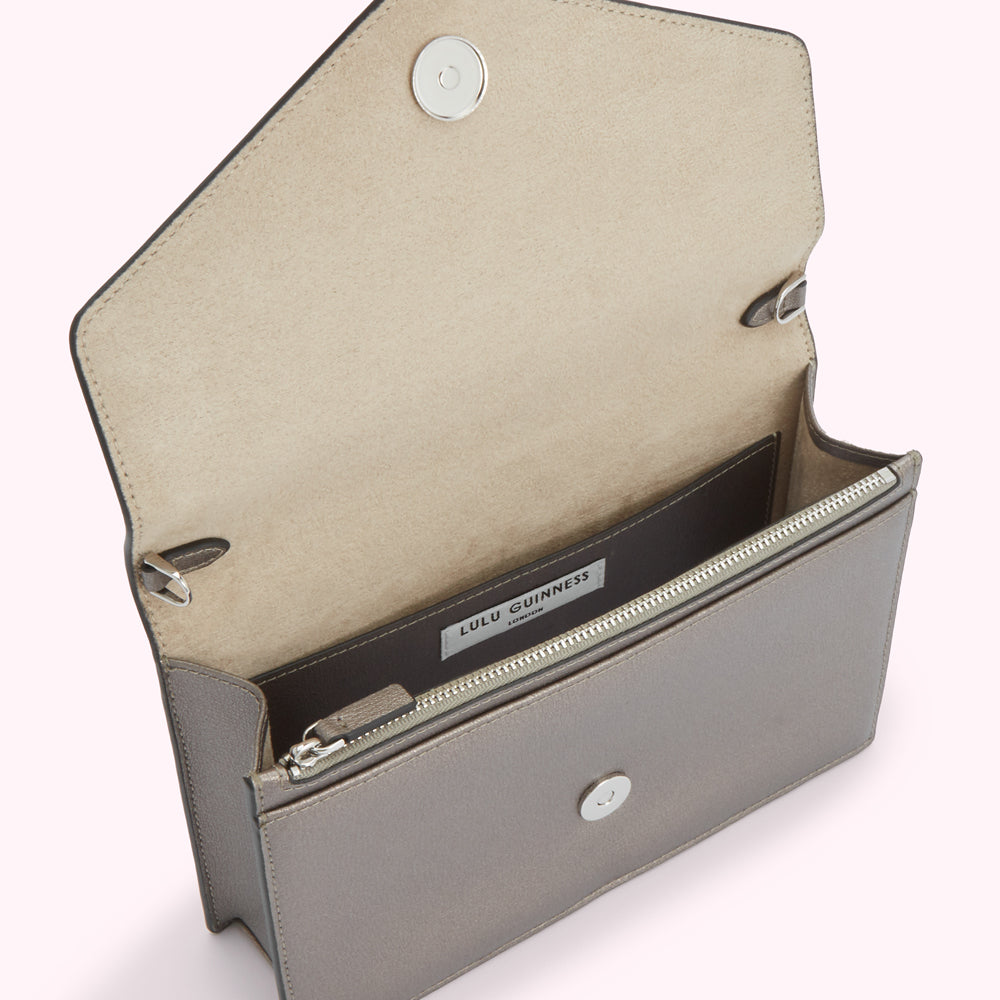 Open grey Lulu Guinness envelope-style clutch with beige interior.
