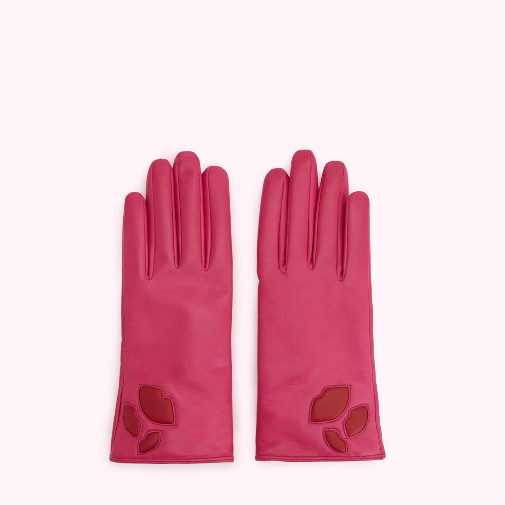 Pair of pink leather gloves with red lip cutouts.
