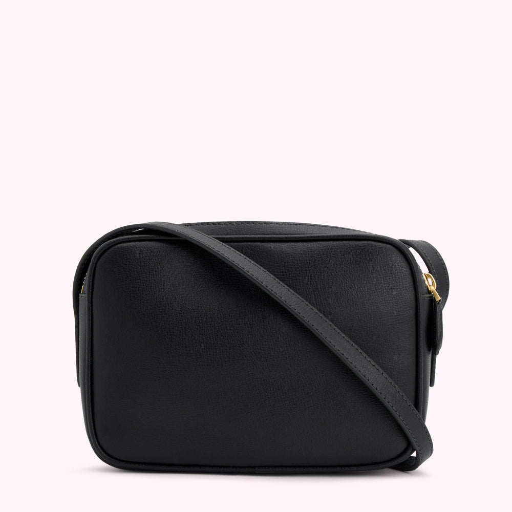 Black leather crossbody bag with gold zipper.

