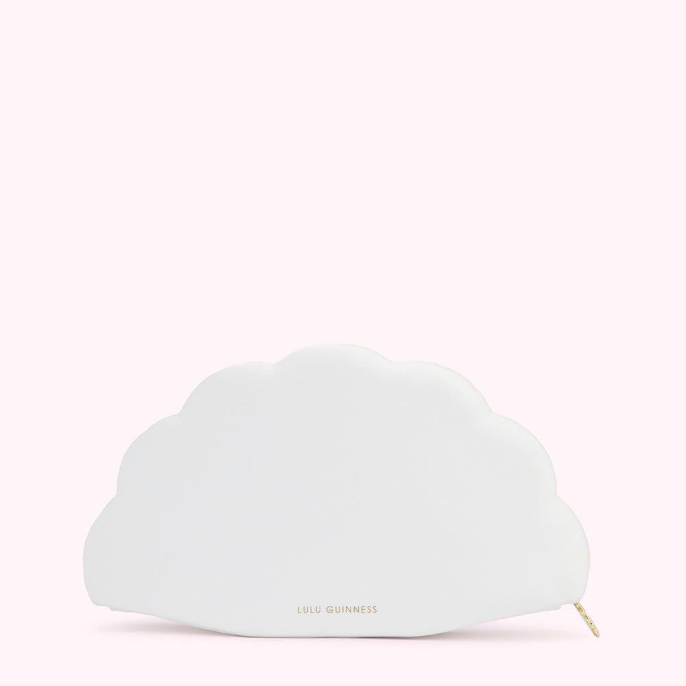 Off-white fan-shaped bag by Lulu Guinness against a light pink background.
