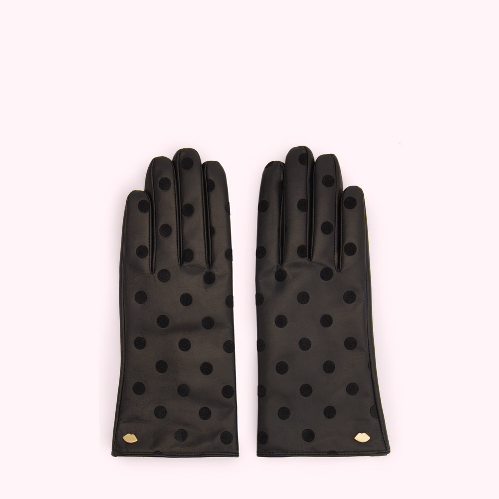 Pair of black leather gloves with black polka dots and a small gold lip detail.
