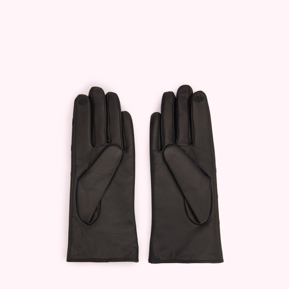 Pair of black leather gloves on a white background.
