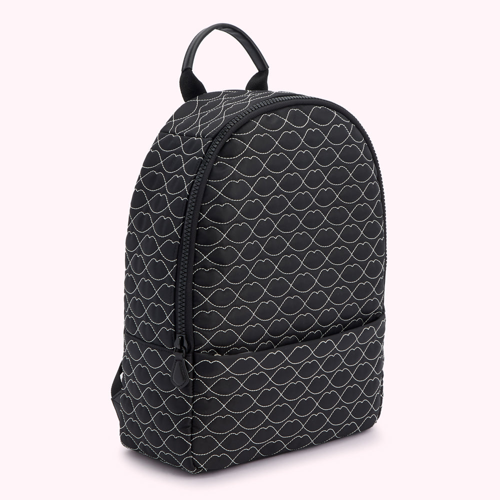 Black backpack with white lip print.