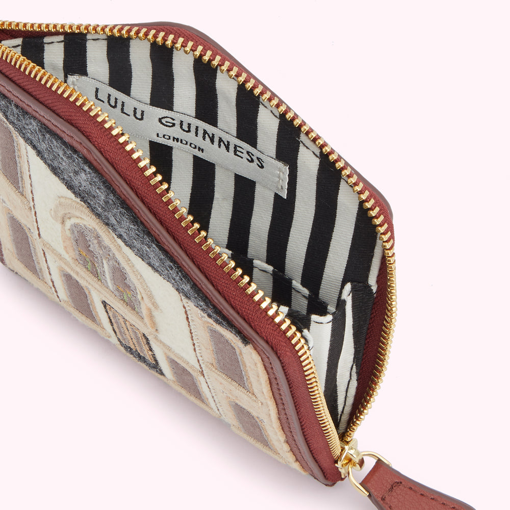 Open Lulu Guinness London zip-around purse with a building design.