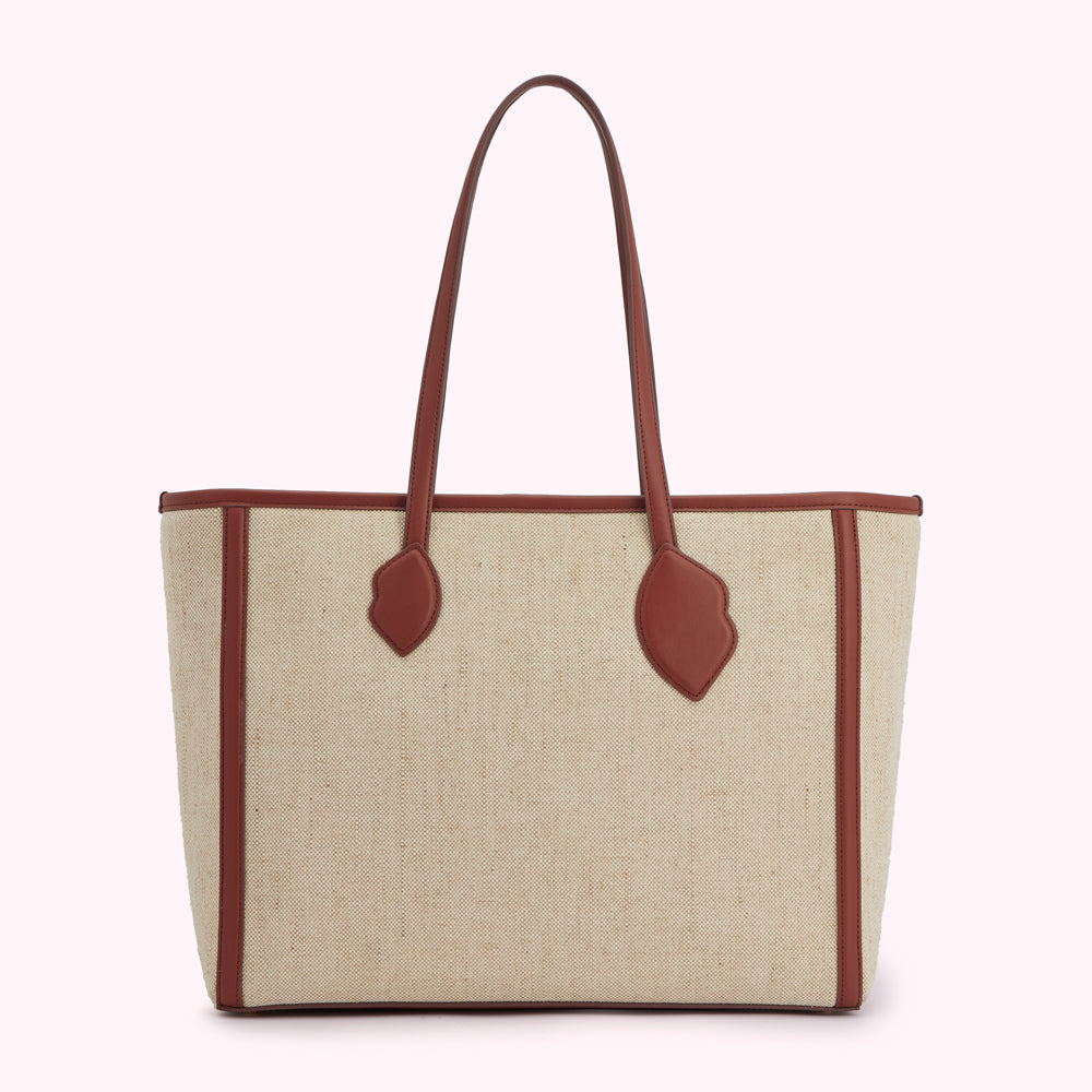 Beige tote bag with brown leather trim and handles.
