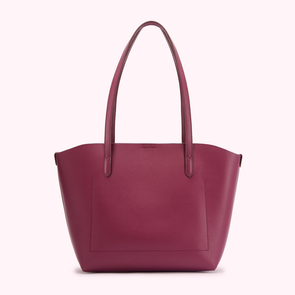 Burgundy leather tote bag on white background.
