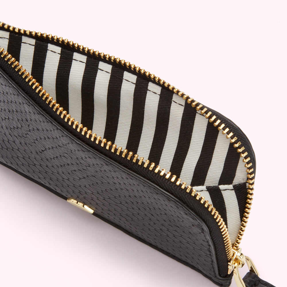Close-up of a black zip-around wallet with a black and white striped interior.