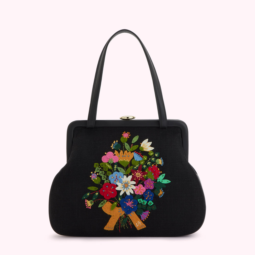 Black handbag with embroidered floral bouquet.