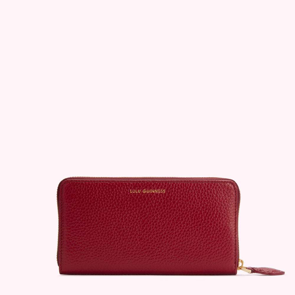 Red leather zip-around wallet by Lulu Guinness.
