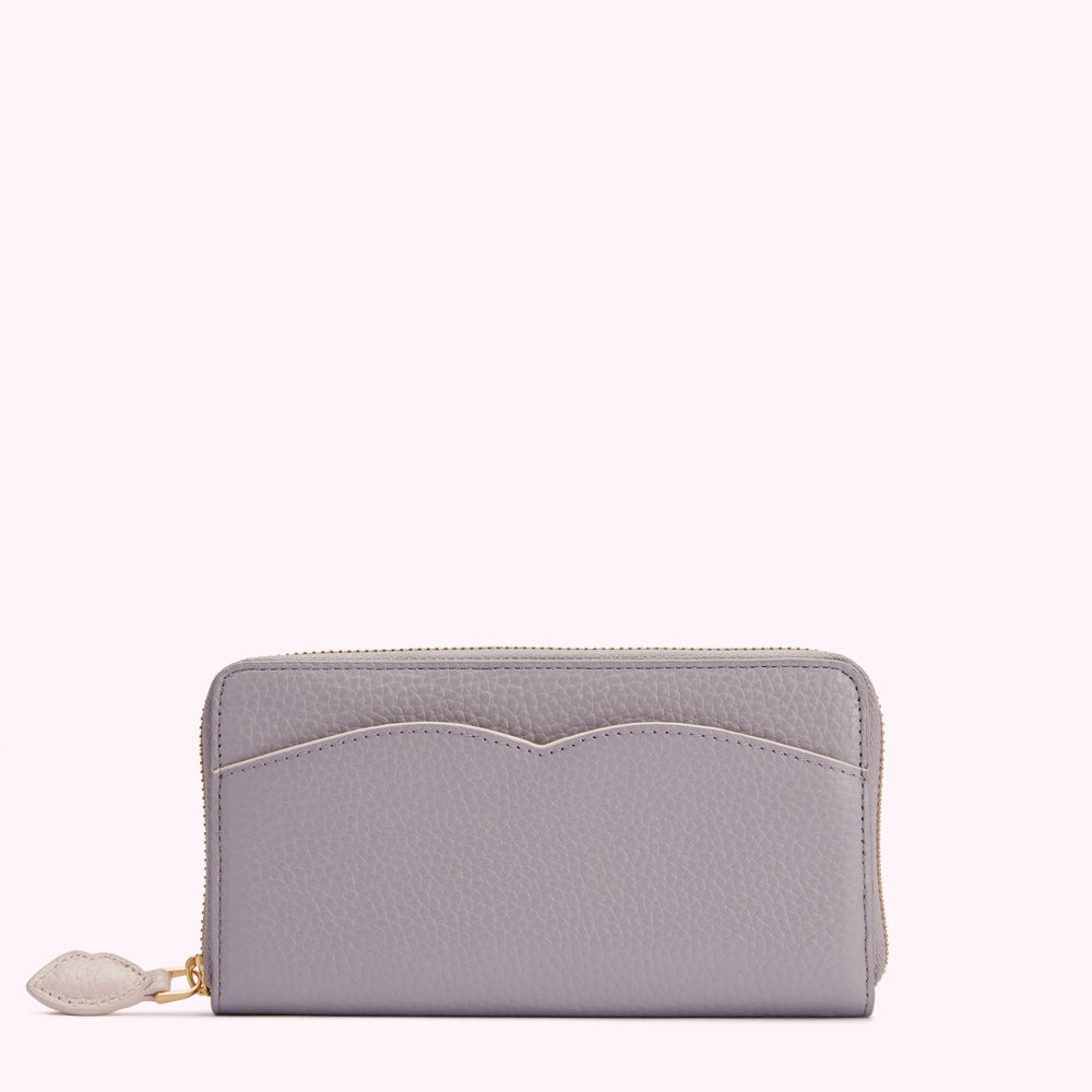 A lavender zip-around wallet on a white background.
