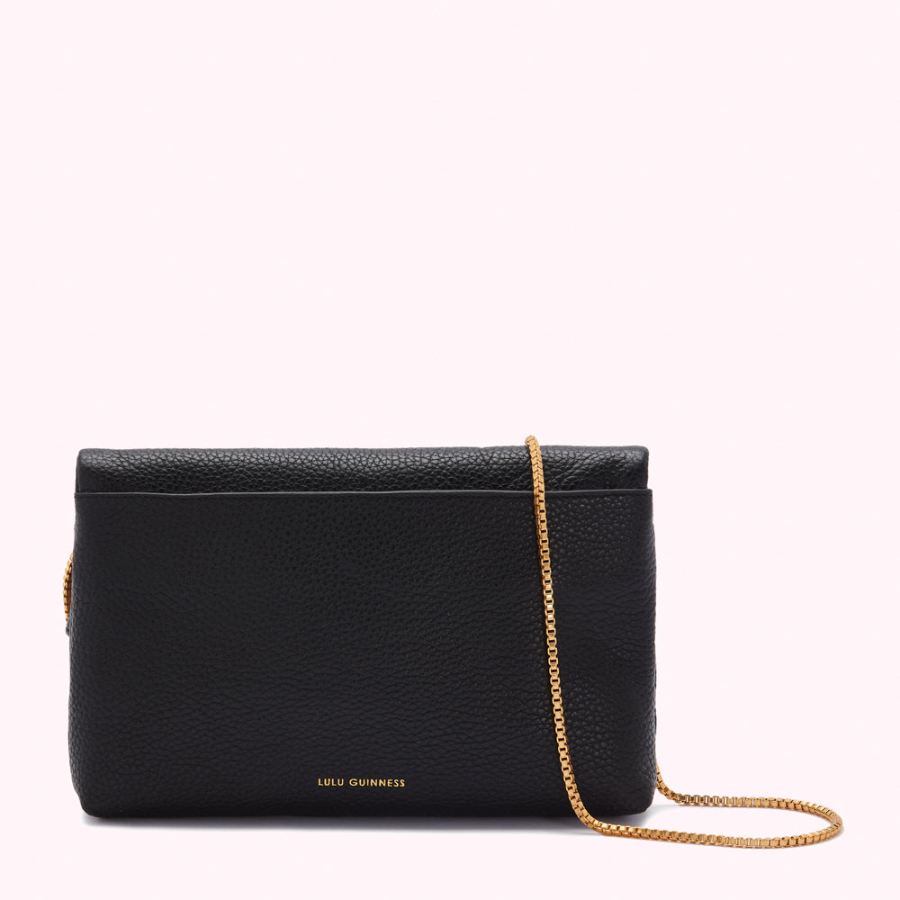 Black Lulu Guinness crossbody bag with gold chain strap.
