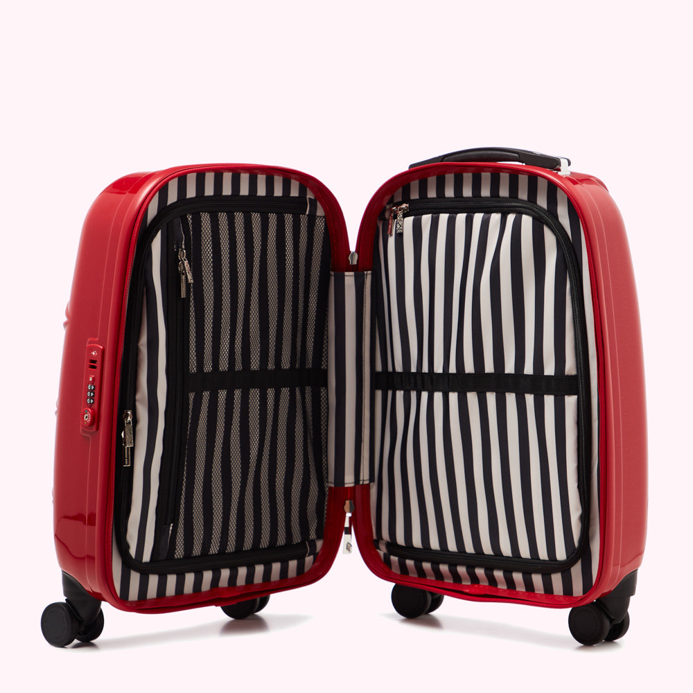 Open red suitcase with black and white striped interior lining against a white background.

