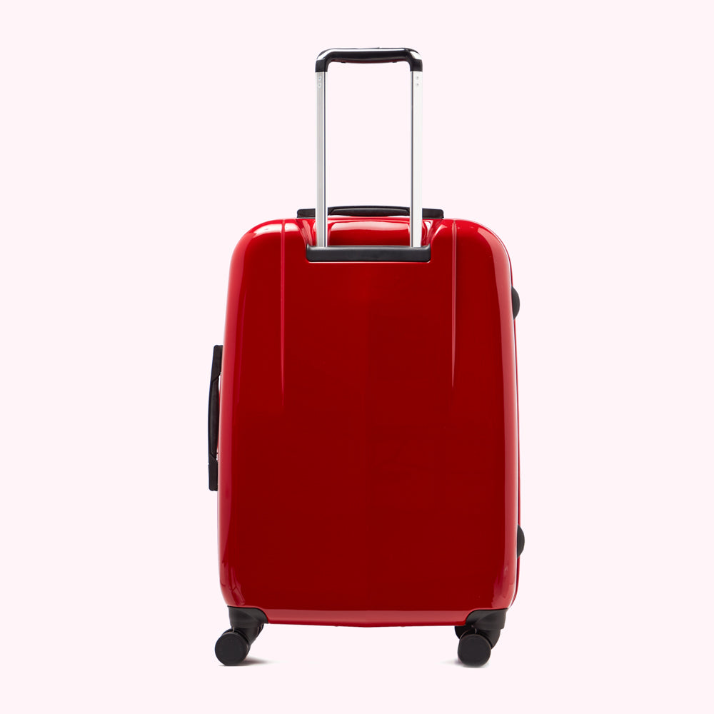 A red suitcase with a silver handle against a white background.
