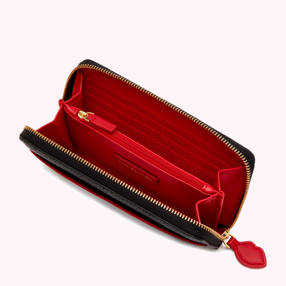 Open black zip-around wallet with red interior.
