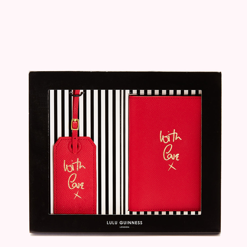 Red Lulu Guinness passport holder and luggage tag gift set in a black box. The items are red leather with gold "With Love x" lettering.