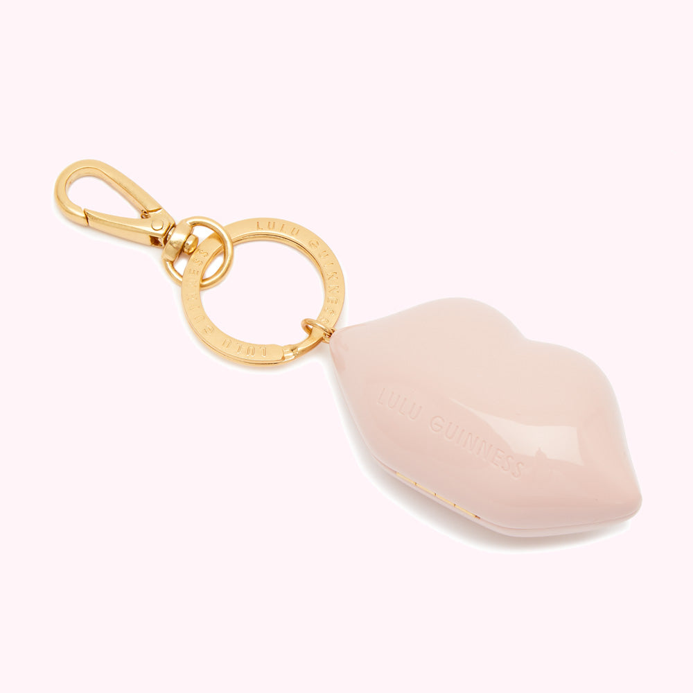 Pink Lulu Guinness lip-shaped keyring with gold clasp and branding.
