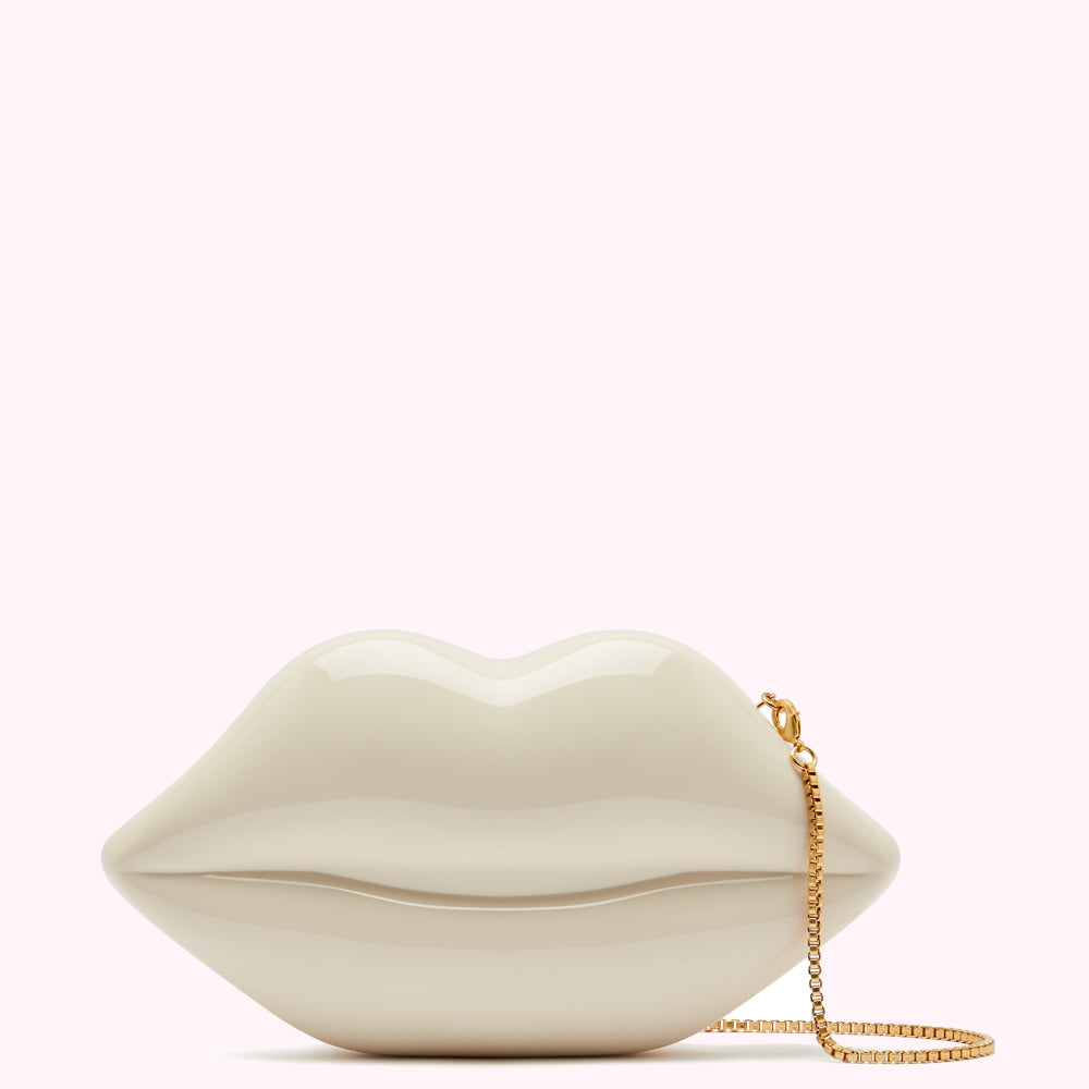 Off-white lip-shaped clutch with gold chain strap.
